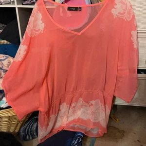 A pink sheer blouse